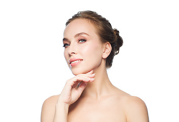 Image showing beautiful young woman touching her face