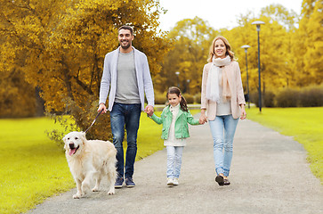 Image showing happy family with labrador retriever dog in park