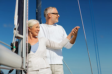 Image showing happy senior couple on sail boat or yacht in sea