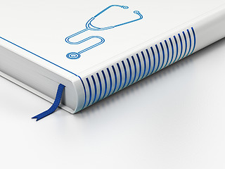 Image showing Healthcare concept: closed book, Stethoscope on white background