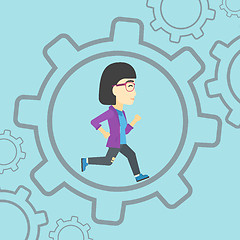 Image showing Business woman running inside the gear.