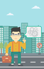 Image showing Businessman pointing at cogwheels.