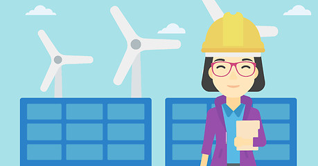 Image showing Female worker of solar power plant and wind farm.