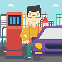 Image showing Worker filling up fuel into car.