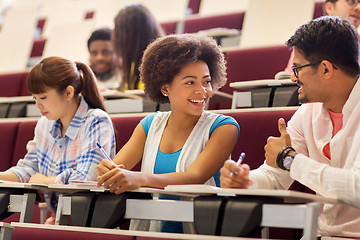 Image showing group of students with notebooks in lecture hall