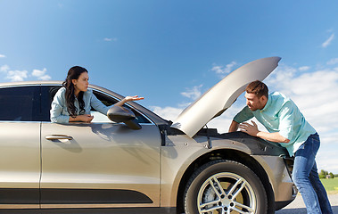 Image showing couple with open hood of broken car at countryside