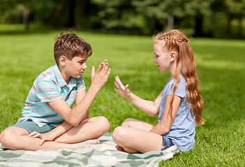 Image showing happy kids playing rock-paper-scissors game