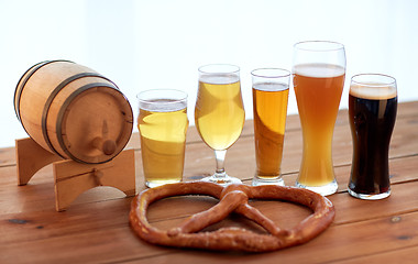 Image showing close up of beer glasses, barrel and pretzel