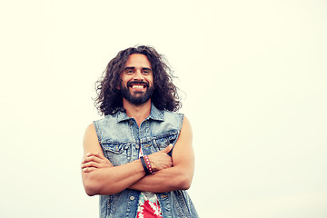 Image showing smiling young hippie man in demin vest