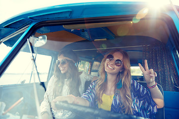 Image showing smiling young hippie women driving minivan car