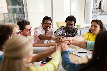 Image showing group of international students with hands on top