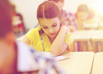 Image showing group of school kids writing test in classroom