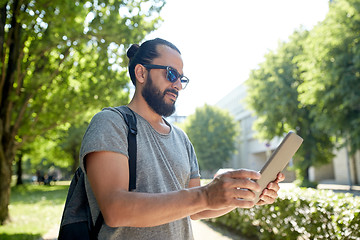 Image showing man traveling with backpack and tablet pc in city