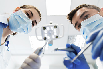 Image showing close up of dentist and assistant at dental clinic