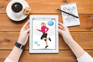 Image showing close up of woman with fitness app on tablet pc