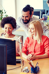 Image showing happy creative team with computer in office