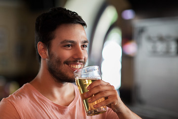 Image showing happy man drinking beer at bar or pub