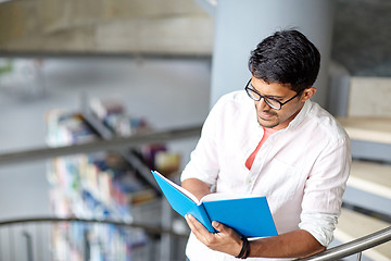 Image showing hindu student boy or man reading book at library