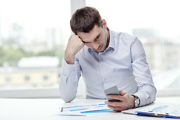 Image showing close up of businessman with smartphone