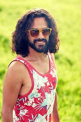 Image showing smiling young hippie man on green field