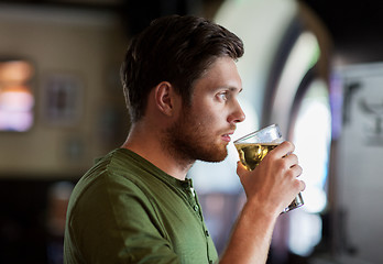 Image showing young man drinking beer at bar or pub