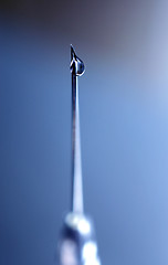 Image showing syringe close-up, focus on the drop