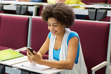 Image showing african student girl with smartphone on lecture