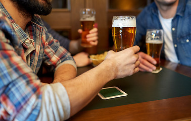 Image showing happy male friends drinking beer at bar or pub