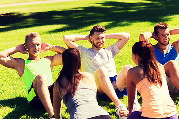 Image showing group of friends or sportsmen exercising outdoors