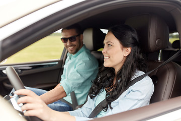 Image showing happy man and woman driving in car