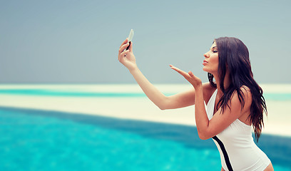 Image showing young woman taking selfie with smartphone