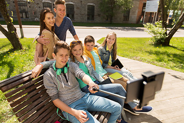 Image showing happy teenage students taking selfie by smartphone