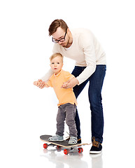 Image showing happy father and little son on skateboard