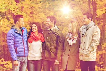 Image showing group of smiling men and women in autumn park