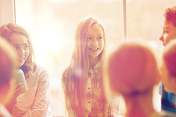 Image showing group of school kids with soda cans in corridor