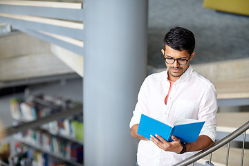 Image showing hindu student boy or man reading book at library