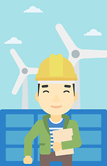 Image showing Male worker of solar power plant and wind farm.