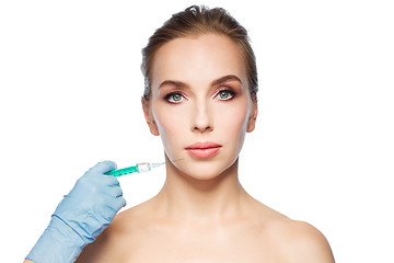 Image showing woman face and hand with syringe making injection