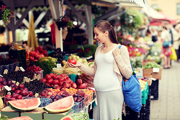 Image showing pregnant woman choosing food at street market