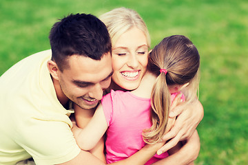 Image showing happy family hugging outdoors