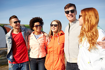 Image showing happy teenage friends in shades talking on street