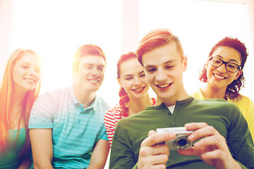 Image showing smiling students with digital camera at school