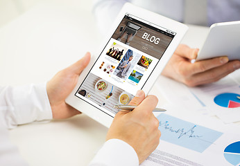 Image showing close up of hands with internet blog on tablet pc