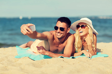 Image showing happy couple in swimwear walking on summer beach