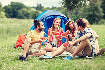 Image showing happy friends eating watermelon at camping