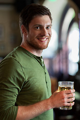 Image showing happy man drinking beer at bar or pub