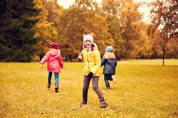 Image showing group of happy little kids running outdoors