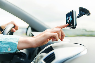 Image showing close up of man with gadget on screen driving car