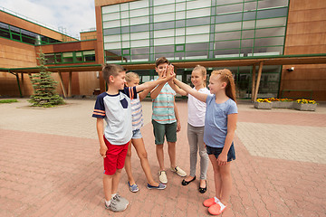 Image showing group of children making high five at school yard