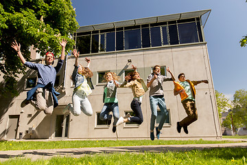 Image showing happy teenage students or friends jumping outdoors